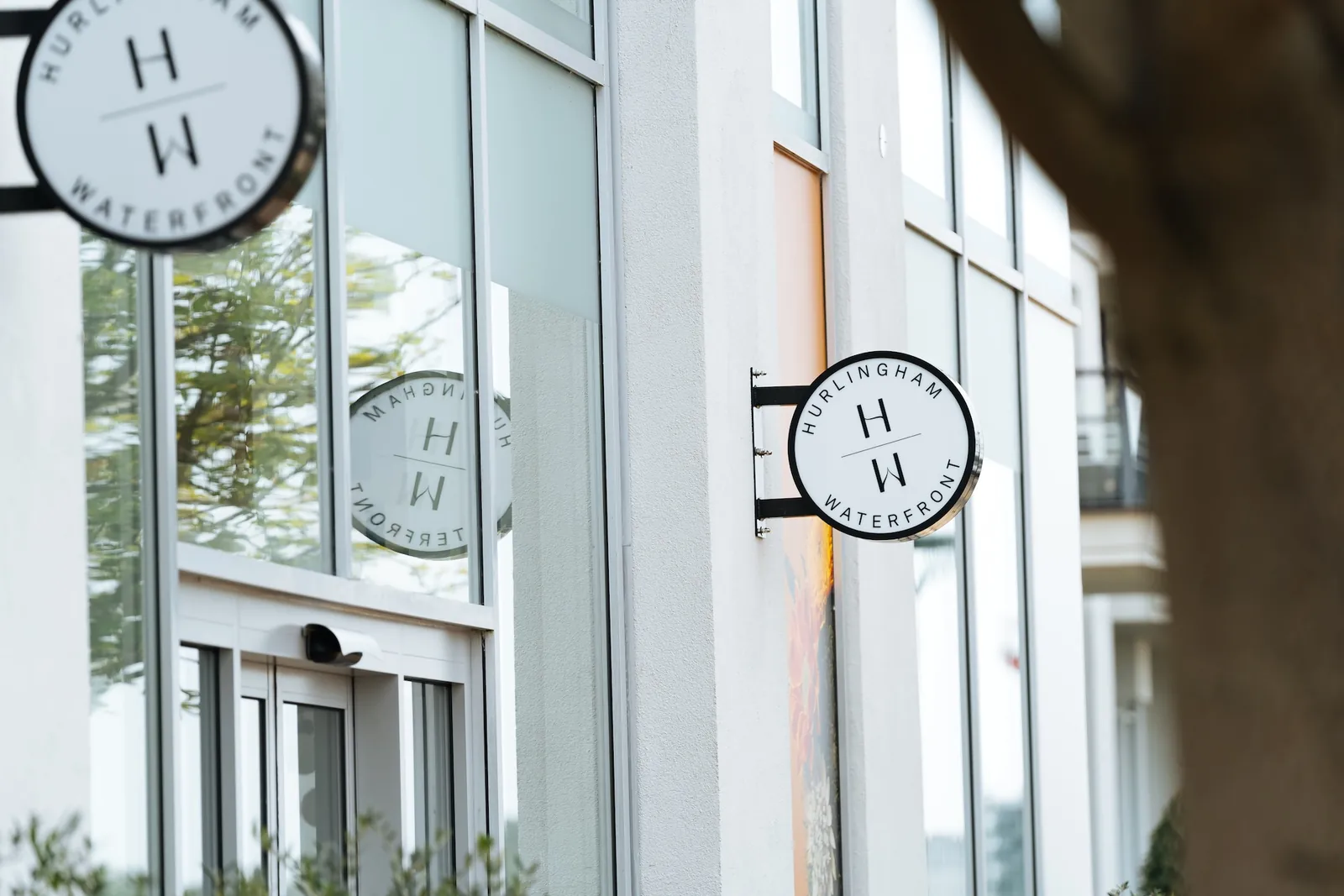 Hurlingham Waterfront marketing-centre entrance and circular brand signs